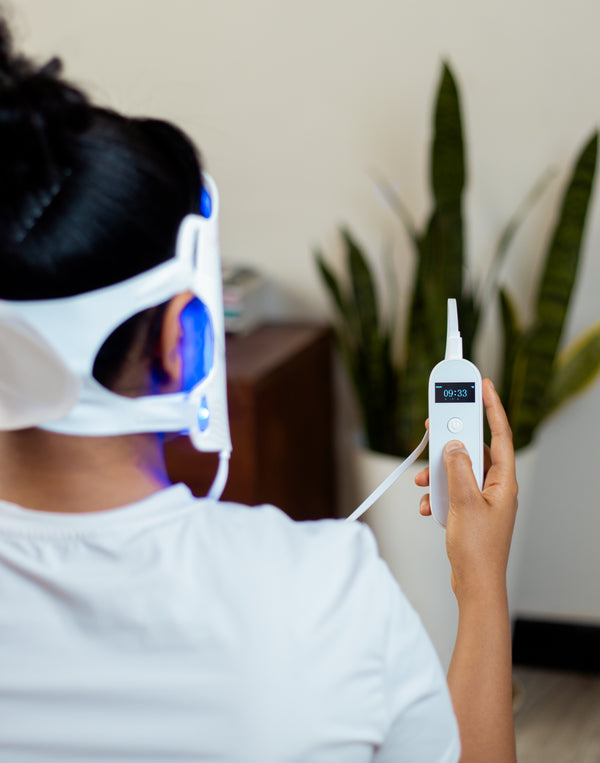 How to use byTheia Advanced LED light therapy mask step 3 - use OLED controller to select treatment mode and set brightness intensity to 50 75 or 100 percent